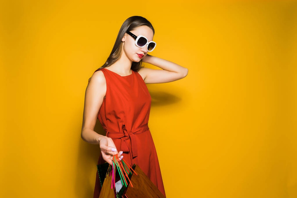 stylish young girl shopaholic in sunglasses bought many gifts - Фото, зображення