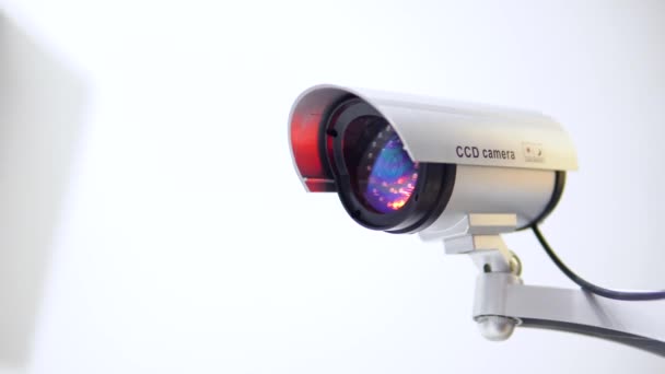 The surveillance camera with flashing red light on white background. Close up - Footage, Video