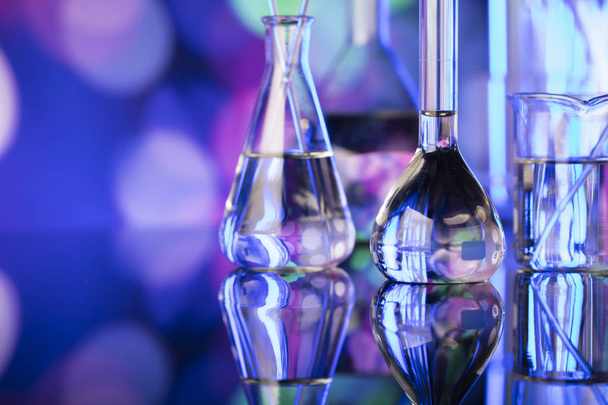 Science experiment concept background. Laboratory beakers, microscope, pipette.  Bokeh background. - Photo, Image