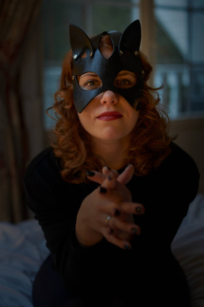 Young redheaded woman in seductive cat's mask - Fotoğraf, Görsel