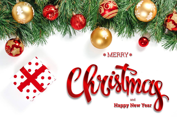 The inscription of Merry Christmas and Happy New Year, green spruce, toys and gifts on a white background. Christmas card, festive background. Mixed media. - Foto, Imagen
