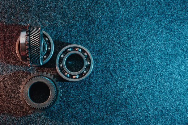 Gears and bearings on a dark background. Top view, flat design. Automotive concept. - Photo, image