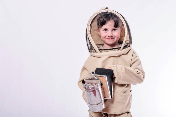 A little girl wears an over sized bee suit in studio white background. - Фото, изображение