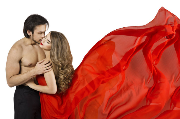 Couple Kiss, Sexy Man Kissing Beautiful Woman, Girl Model in Red Waving Dress Fabric over White background - Foto, afbeelding