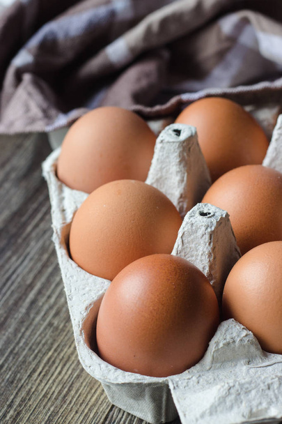 Raw chicken eggs in a cardboard tray. Ingredients for cooking - Φωτογραφία, εικόνα
