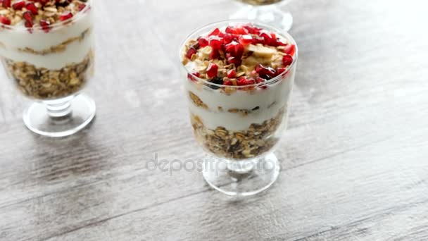 Zoom in over top view on delicious home made muesli with natural yogurt and pomegranate - Footage, Video