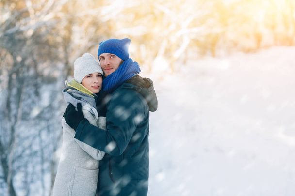 Happy Young Couple in Winter Park laughing and having fun. Family Outdoors. - Fotografie, Obrázek
