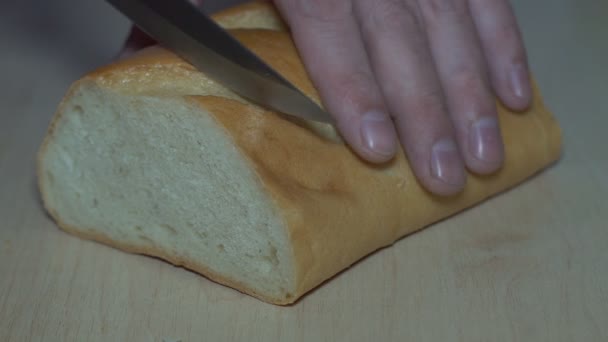 Slicing bread with a knife Bread being sliced then buttered with butter. - Footage, Video