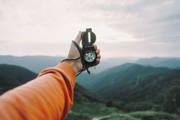POV image with compass in mountains - Zdjęcie, obraz