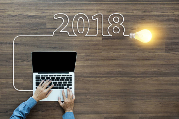 Creative light bulb idea 2018 new year, With businessman working on laptop - Fotó, kép