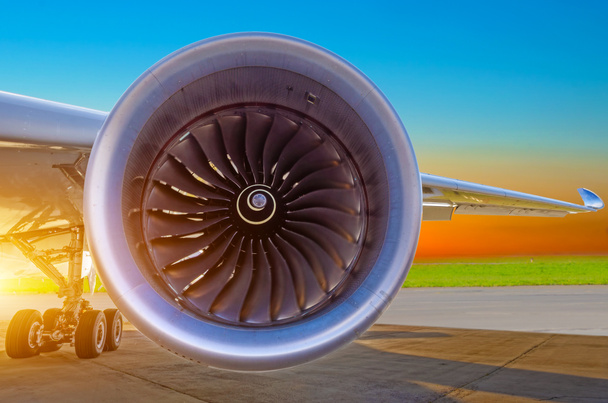 A modern repülőgép motor zár megjelöl, és a naplementét az égen. - Fotó, kép