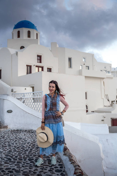 Portrait of young woman at beautiful Santorini city, Greece - Zdjęcie, obraz