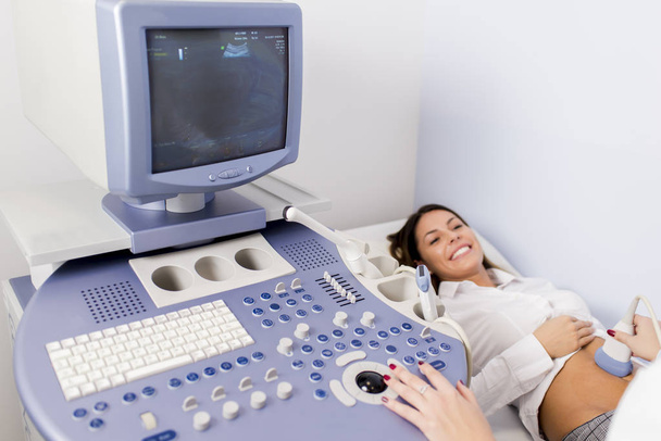 Pregnant young woman at gynecologist having examined with ultras - Photo, Image