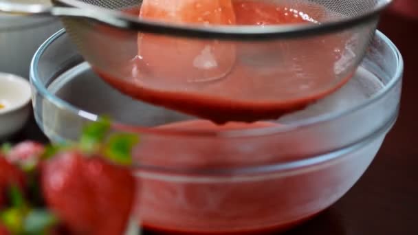 Wipe strawberries through a sieve. Strawberry sauce - Footage, Video