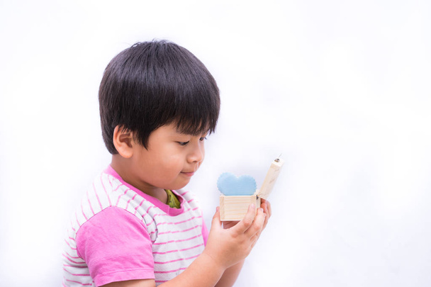 Cute Asian little boy holding blue heart in box wooden on white, - Φωτογραφία, εικόνα