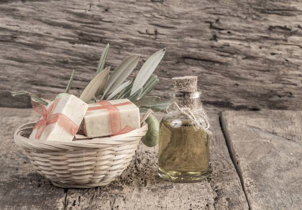 natural olive oil soap bars and olive oil bottle on wooden table - Photo, Image