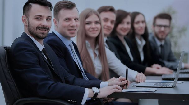 Confident businessman looking at camera among colleagues - Photo, image