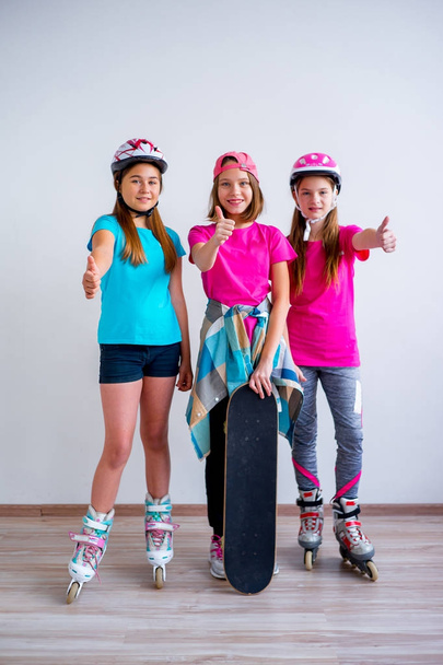 Teens with skateboards and rollerskates - 写真・画像