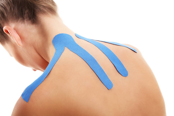 Picture showing special physio tape put on injured back over white background - Photo, image