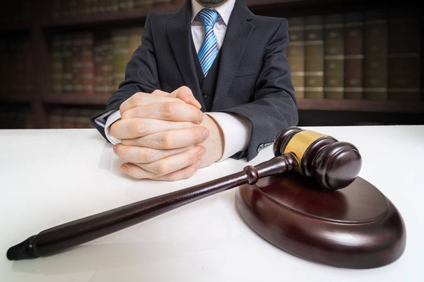 Έννοια της δικαιοσύνης και του δικαίου. Δικηγόρος με σταυρωμένα τα χέρια και σφυρί σε  - Φωτογραφία, εικόνα