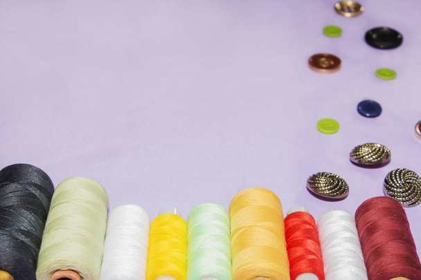 needlework and tailoring concept - sewing buttons, spools of thread and cloth - Photo, Image
