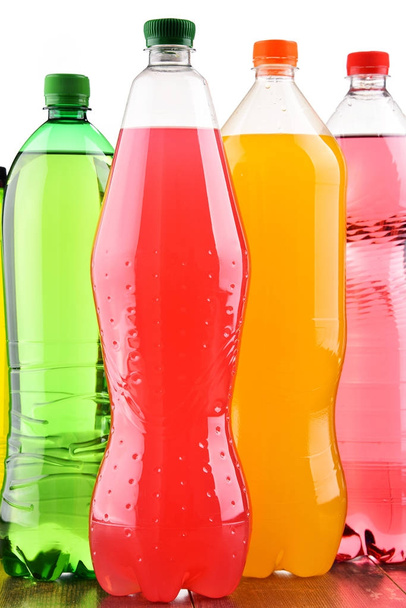 Plastic bottles of assorted carbonated soft drinks over white background - Photo, Image