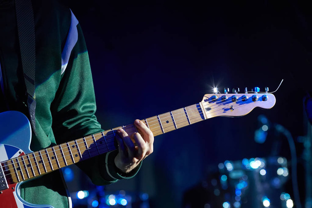 Closeup of guitarist with guitar. - Фото, изображение