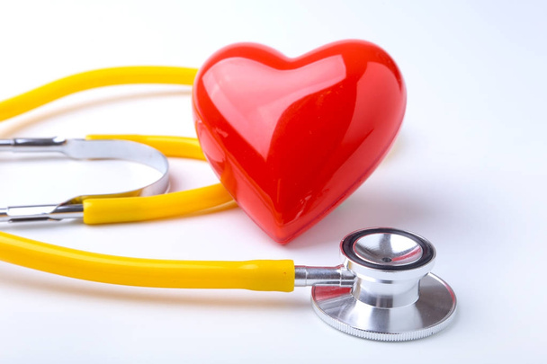 Red heart and a stethoscope on white background - Zdjęcie, obraz