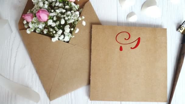 I Love You Vintage Written animation text on kraft envelope on white wooden background. Calligraphy and lettering flourish elements for Valentines Day wedding or other holidays - Footage, Video