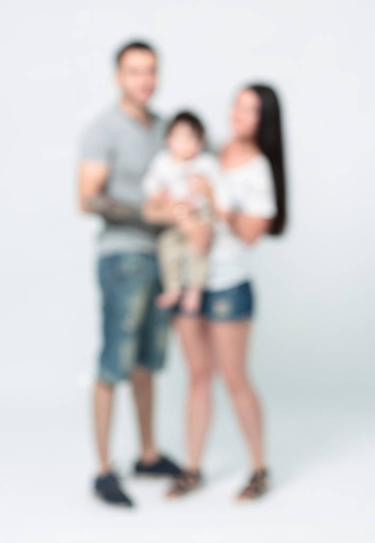 Blurred view of a family portrait with a child - Foto, Imagen
