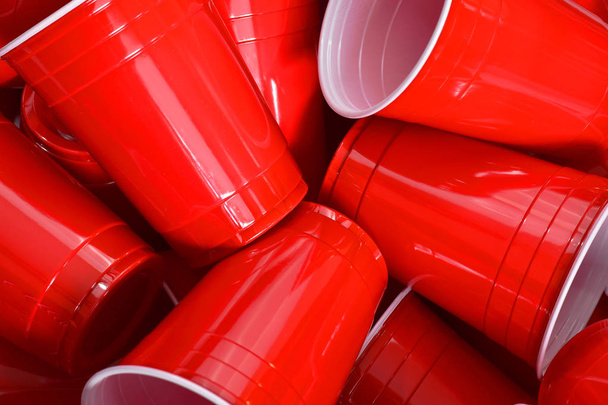 An abstract image of a pile of red plastic drinking cups.  - Photo, Image