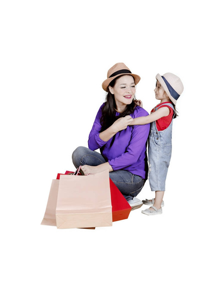 Mother and child carrying shopping bags on studio - Photo, image