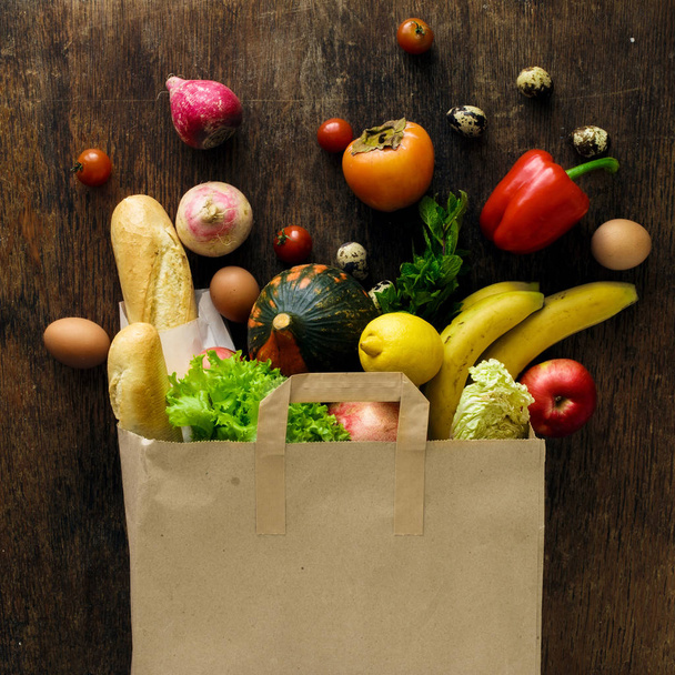 Top view paper bag different health food wooden background - 写真・画像