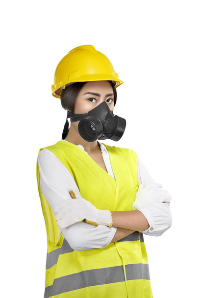 Portrait of asian woman construction worker with protective mask posing isolated over white background - Foto, Bild