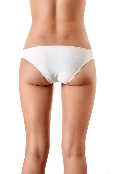 Perfect female body, buttocks close-up in white underwear, isolated on white background. The concept of beauty, plastic surgery. - Foto, Imagem