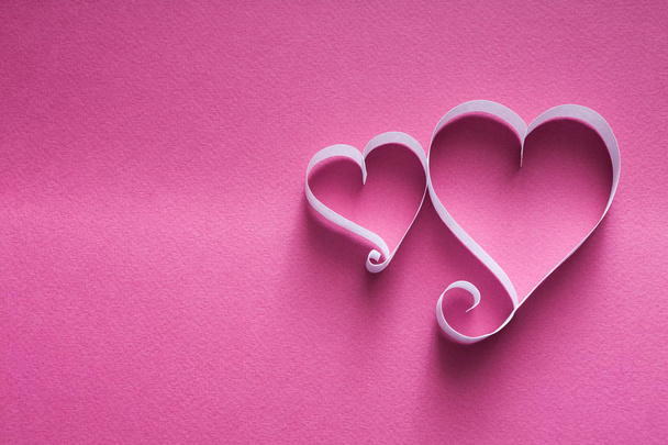 Handmade paper heart shapes decoration on pink background - Photo, Image