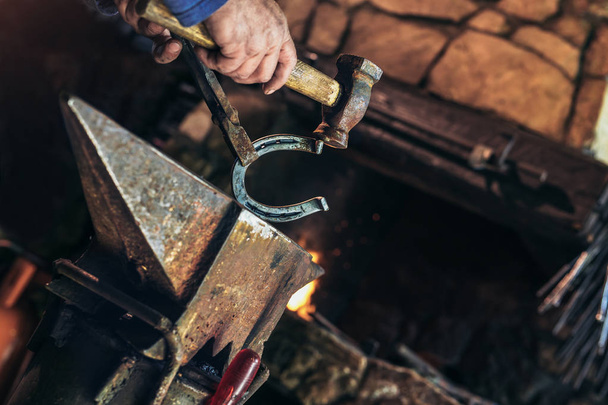 Blacksmith forging a horseshoe - Photo, Image