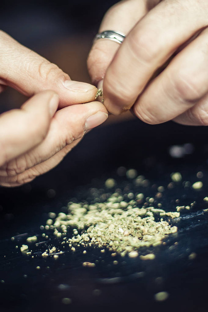 Preparing marijuana cannabis joint. Drugs narcotic concept - Photo, image
