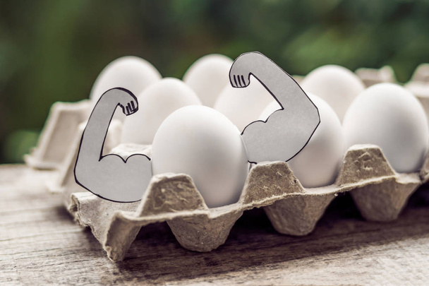 Egg with muscles, concept of egg protein, sports nutrition, diet - Foto, Bild