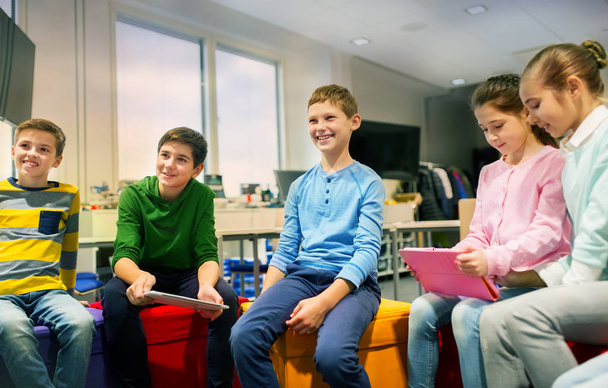 group of happy children with tablet pc at school - Φωτογραφία, εικόνα