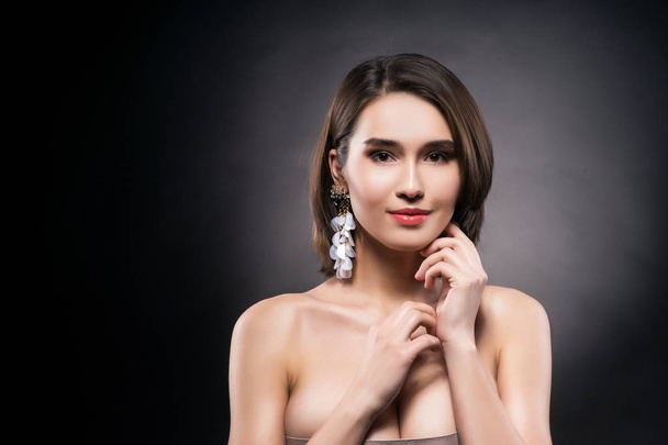 Beautiful mixed asian-caucasian race girl wearing earrings - Фото, изображение