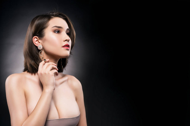 Beautiful mixed asian-caucasian race girl wearing earrings - Valokuva, kuva
