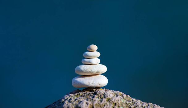 Balanced several white stones on blurred beautiful background - Photo, Image