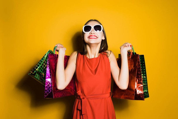 happy stylish girl in sunglasses bought a lot of gifts for the new year - Φωτογραφία, εικόνα