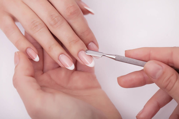Closeup shot of a woman in a nail salon receiving a manicure by  - Photo, Image