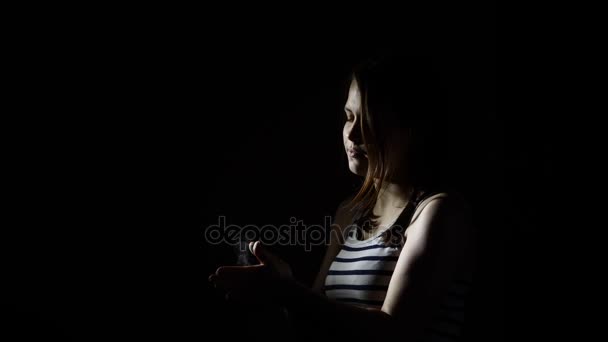 Teen girl with chalk in darkness before lift slow motion. Clapping hands. - Footage, Video
