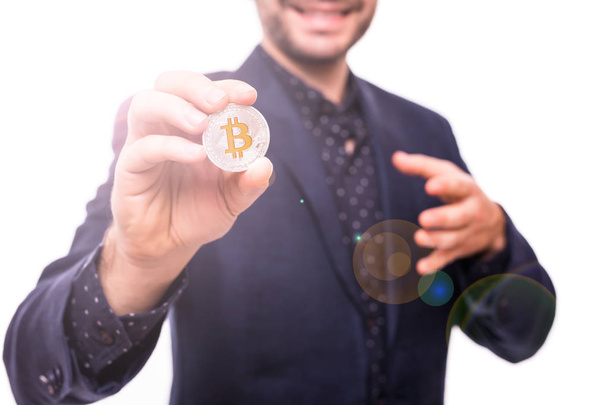 Nahaufnahme eines gutaussehenden Geschäftsmannes im Anzug mit silbernem Bitcoin in der Hand isoliert auf weißem Hintergrund - Foto, Bild