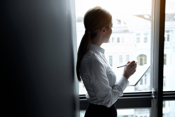 Businesswoman watching at street in room - Photo, Image