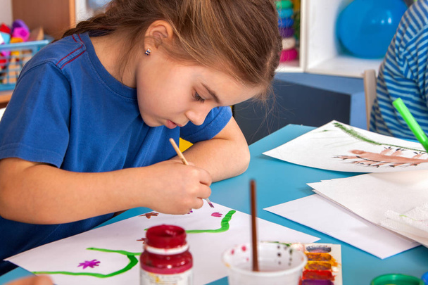 Small students children painting in art school class. - Fotó, kép