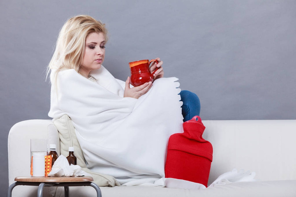 Woman being sick having flu lying on sofa - Foto, Imagen